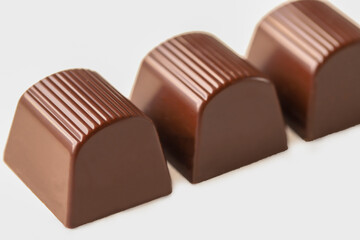 Milk chocolate cubes isolated on white background