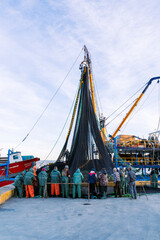 fisherman fishing boats on Bosporus Istanbul on a Foggy sunrise. Rainy clouds and dark weather. seagulls flying over the sea