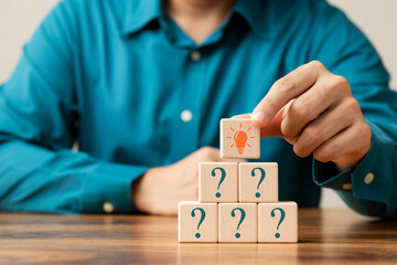 Creative concept. Think different, wooden cube with question mark and light bulb sign.