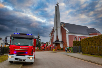 Fire brigade called to damaged church roof after a storm. Poland