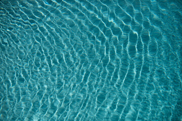 Pool water background, blue wave abstract or rippled water texture background.