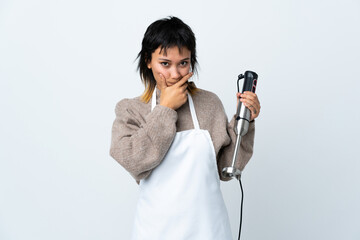 Chef Uruguayan girl using hand blender over isolated white background thinking an idea