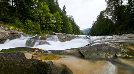 Fototapeta na wymiar The mountain river Prut and waterfalls Probiy in Yaremche, Carpathians, Ukraine