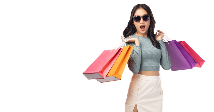 Shopping girl get surprised Surprised happy asian woman open mouth with exciting Beauty young female hold shopping bags Isolated on white background and copy space Expressive facial expression
