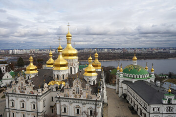 Fototapeta na wymiar Monastery with golden cupola on the hill, Pechersk Lavra, orthodox monastic complex, known for its network of catacombs, Kyiv, Ukraine