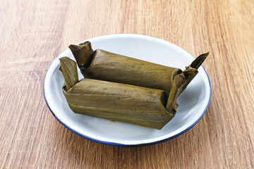 Arem-arem, a traditional Indonesian food made from rice filled with vegetables, chicken, meat or tempeh wrapped in banana leaves. Arem-arem is popular as a breakfast substitute. Selected focus.
