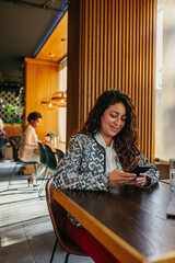 Young businesswoman using a smartphone at cafe