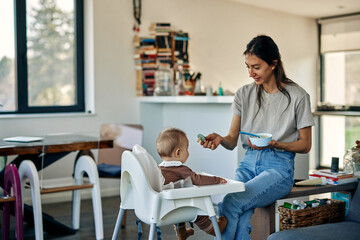 Happy baby and mother during lunchtime