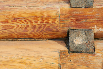 Texture of natural wood close up. New log house. Yellow lacquered wood. The outer surface of a rural residential building. Ecology concept.
