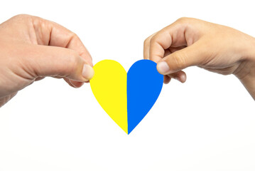 Two hands holding heart with Ukrainian flag on white background.