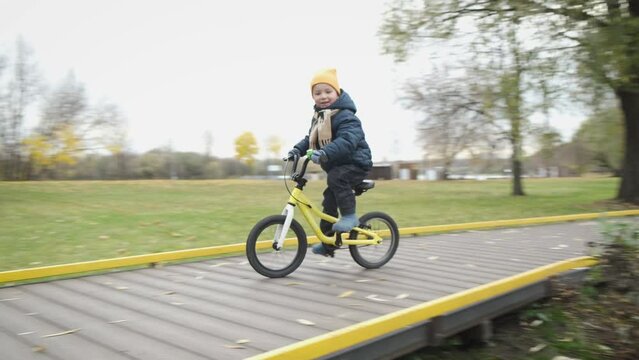 Fall From Bike. Child On Bicycle Riding Along Path In City Park And Falling Down. Sport Children's Injuries. Joint Injury During Outdoor Activities. Accident With Bicycle.