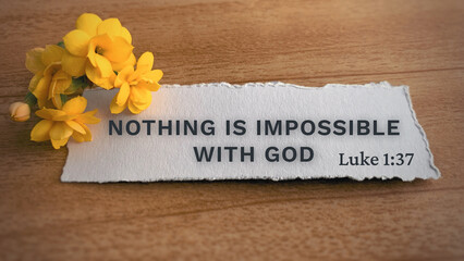 Top view of Bible verse Nothing is impossible with God. Yellow flower and wooden background. - obrazy, fototapety, plakaty