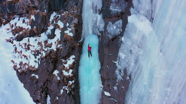 Ice Climbing on Frozen Waterfall, Aerial View. Barskoon Valley, Kyrgyzstan. Drone is Orbiting