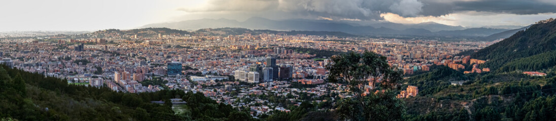 Panorama of the high plateau with the Colombian capital Bogota with dramatic cloudy sky and sunlight
