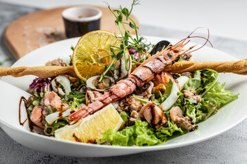 Healthy salad plate seafood eggs and shrimps. Food recipe background. Close up