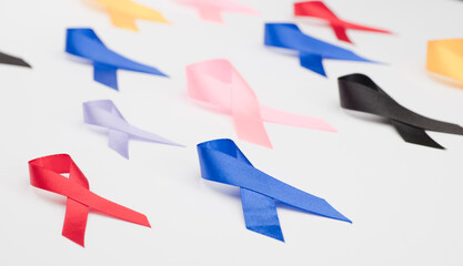 Fototapeta na wymiar ribbon red, blue, purple, black, different colors on white background, disease awareness concept