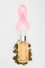 pink cancer ribbon with, oil bottlel with buds, white background ,Isolated background,