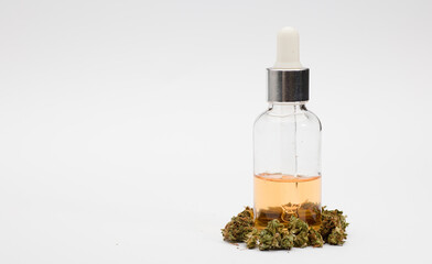 CBD (Cannabidiol) oil with bottle and dropper with buds. White background. CBD isolated hemp oil. THC-free