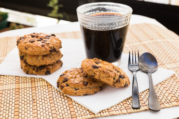 cookies with chocolate and hazelnuts and coffee are on table