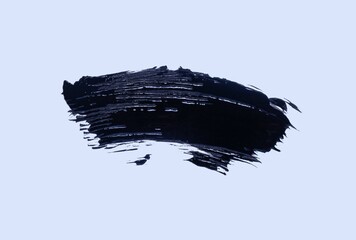 Photo of black mascara for eye lashes smudge texture background isolated on white