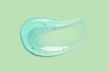 Cream gel gren transparent cosmetic sample texture with bubbles isolated on green background