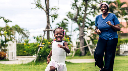Portrait of enjoy happy love black family african american mother with little african girl child smiling and play having fun moments good time in park at home