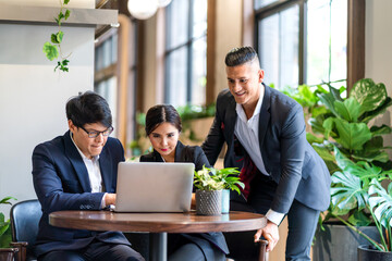 Group of business colleague team discussing meeting strategy sharing idea with marketing job project.Creative business people work with laptop computer in green plant terrace decorated workloft
