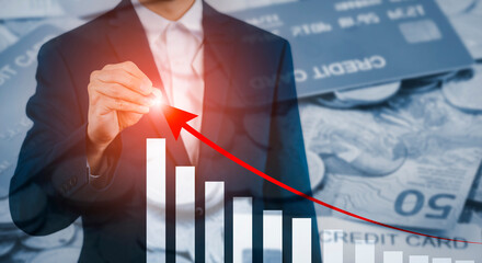 Businessman using pen write growth graph losses on the stock market chart concept, Business use pen...