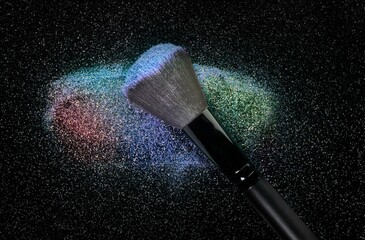 Shimmering multi colored glow eye shadow cosmetic powder smudge brush stroke on black glowing background