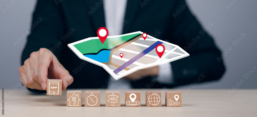 Poster hand hold wooden block cube and model map with location point , gps app, icon travel maps and find p