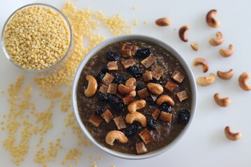 Sweet Pongal. An Indian sweet dish made of white rice and yellow moong lentils and jaggery. Garnished with ghee fried cashews nuts and coconut bits