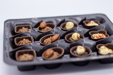 Few chocolates in brown box