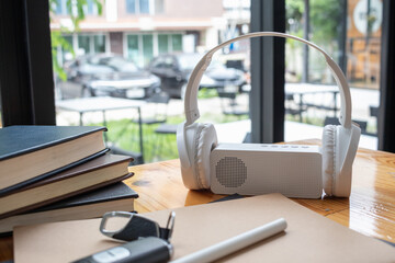 The white wireless headphones place on top of the MP3 player, popular with music lovers during work...