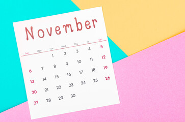 November 2022 calendar on multicolored background.