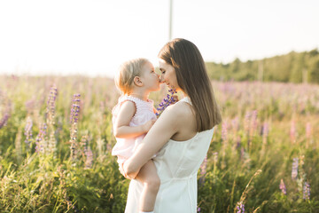 mother holds her child in her arms, nature, calm atmosphere