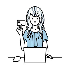 デスクで座ってPCを使いながらクレジットカードを手に持っているオフィスカジュアルの女性