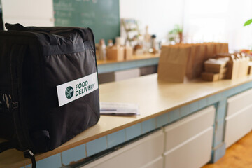 Take away boxes with lunch prepared for delivery in thermo bag in restaurant.