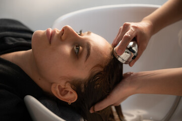 woman client person having a process to making treatment a hair with hairdresser in beauty salon