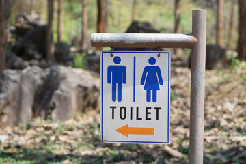 TOILET sign with male ,female and arrow symbols to show the way to toilet at the park. Concept :...