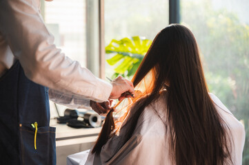 Naklejka premium hairdresser and beautiful client woman making treatment hair health care in fashion style salon