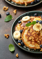American pancakes with banana, blueberry, walnut and honey. Healthy morning breakfast