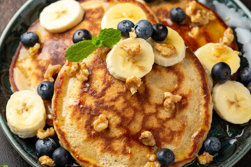 American pancakes with banana, blueberry, walnut and honey. Healthy morning breakfast