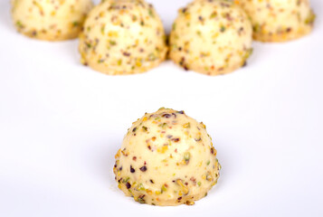 Homemade fruitcakes covered in white chocolate. on a white background