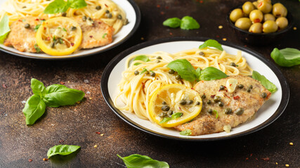 Chicken Piccata with capers, white wine sauce and spaghetti. Italian food