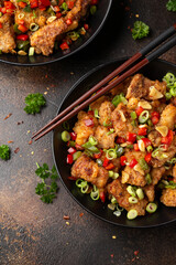 Stir fry salt and pepper pork loin with herbs in black bowl. Asian food
