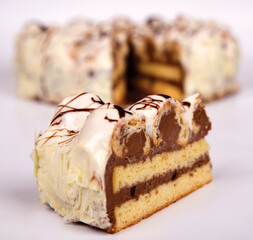 Profiterole Cake, cut into portions, Piece of cake in the background