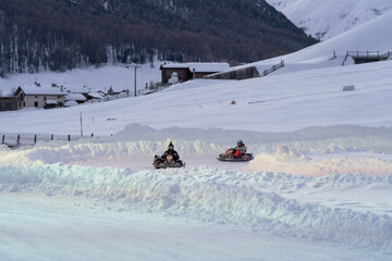 Go karting on icy track in winter. Adult karting drivers in action on outdoor icy track