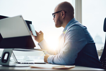 Focused man browsing mobile phone