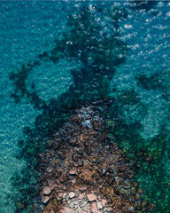 Beach and waves from top view. Turquoise water background from top view. Summer seascape from air. Top view from drone. Travel concept and idea