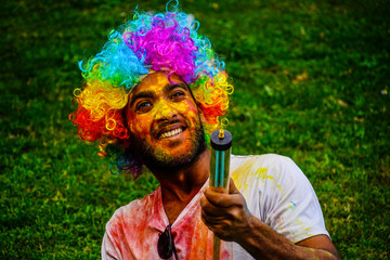 Young Indian playing and enjoying Holi in park Images